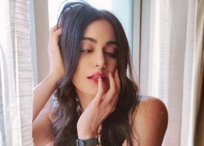 Bollywood actress Adah Sharma looked hot in a stunning red off shoulder gown. Adah looked stunning in a bright red off shoulder gown with a thigh high slit.