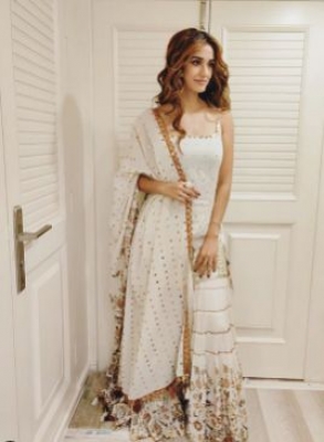Actress Disha Patani chose a pristine white ensemble for the mahurat puja of her upcoming film 