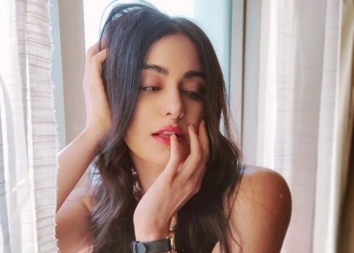 Bollywood actress Adah Sharma looked hot in a stunning red off shoulder gown. Adah looked stunning in a bright red off shoulder gown with a thigh high slit.