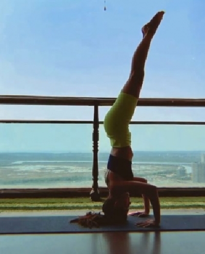 Alaya F pulls off a complicated inversion yoga pose.