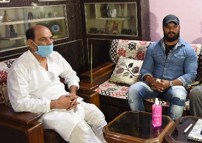 Patna: Bhojpuri actor Khesari Lal Yadav meets Sushant Singh Rajput's father Krishna Kumar Singh, during his visit to the late actor's residence to pay his condolences,  in Patna on June 20, 2020. (Photo: IANS)