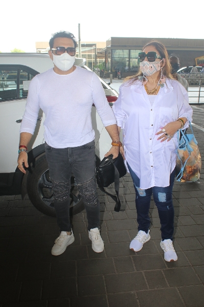 Mumbai: Govinda and his Wife Spotted at Airport Departure On Monday 12th April, 2021. (Photo: IANS)