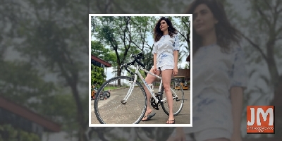 Karishma strikes a pose with her bike