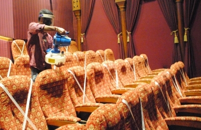 New Delhi: Workers sanitized cinema hall after the reopen from Monday for 50% by Delhi Government at Delight picture hall Daryaganj in New Delhi on Sunday July 25, 2021. (Photo: Qamar Sibtain/IANS)