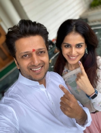 Mumbai: Ritesh Deshmukh with his wife Genelia after casting their vote for Maharashtra assembly elections in Mumbai on Oct. 21, 2019. (Photo: IANS)