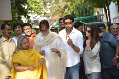 Actors Jaya Bachchan, Amitabh Bachchan, Abhishek Bachchan and Aishwarya Rai Bachchan shows their fore fingers marked with phosphorous ink after casting their vote at a polling booth during the sixth phase of 2014 Lok Sabha Polls in Mumbai on April 24, 2014. (Photo: IANS)